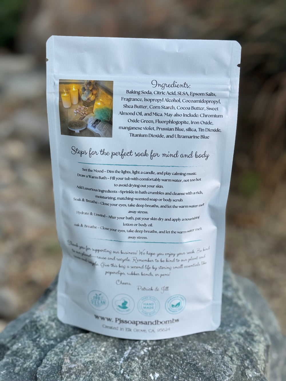 Back of a white packaging pouch with text and images on a blurred natural background
