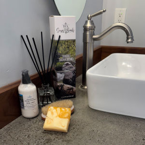 Cinnamon Orange and Clove Scented Collection on a rustic bathroom counter