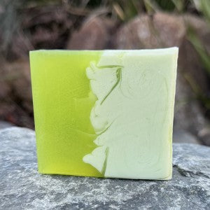Citrusy Lemongrass Soap standing up on a rock in a natural setting