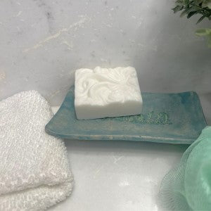 Lifestyle picture of simply white soap sitting on a soap dish