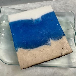 Ocean Shores Soap flat on soap tray showing the 3 layers in the colors of the sand, ocean water and waves