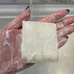Unscented Luxury Soap lathered up being held
