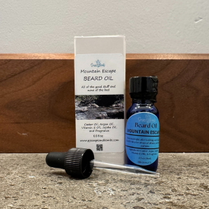 PJ's Soaps and Bombs Beard oil with droper on rustic bath counter