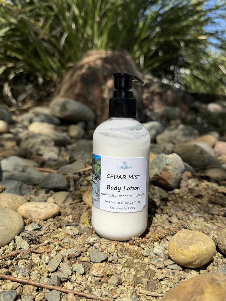 Cedar Mist Body Lotion in natural setting sitting on a rock