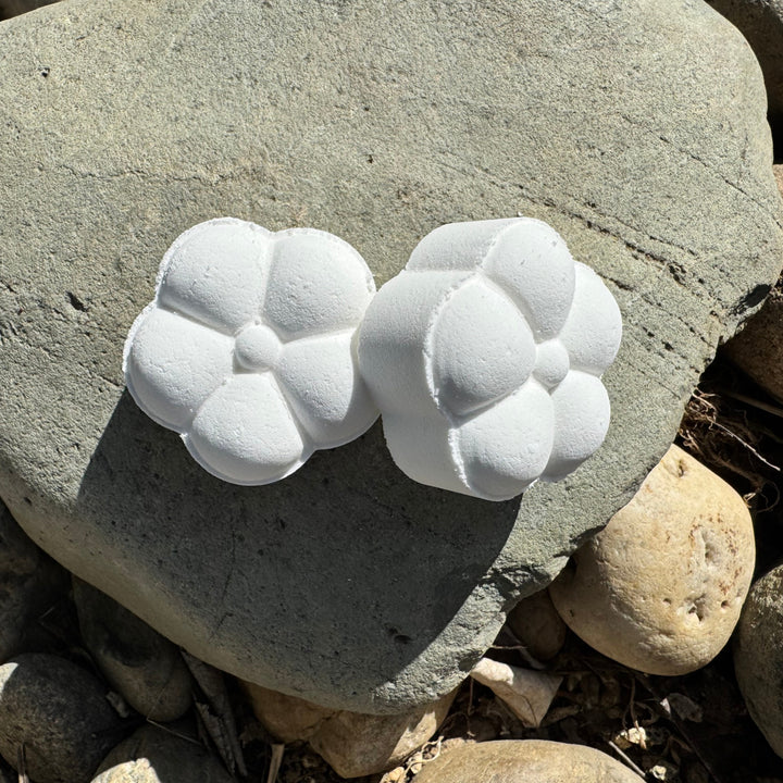 Cedar Mist Shower Steamers, 2 white color steamers sitting on a rock