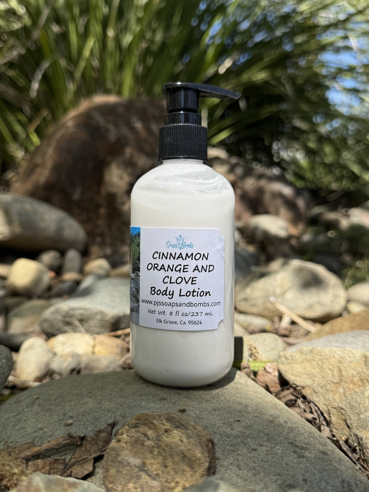 Cinnamon Orange and Clove Body Lotion in natural setting sitting on a rock