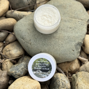 Eucalyptus Escape open jar sitting on a rock in a natural setting