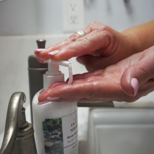 PJ's Soaps and Bombs Body and Hand Lotion being pumped onto fingertips