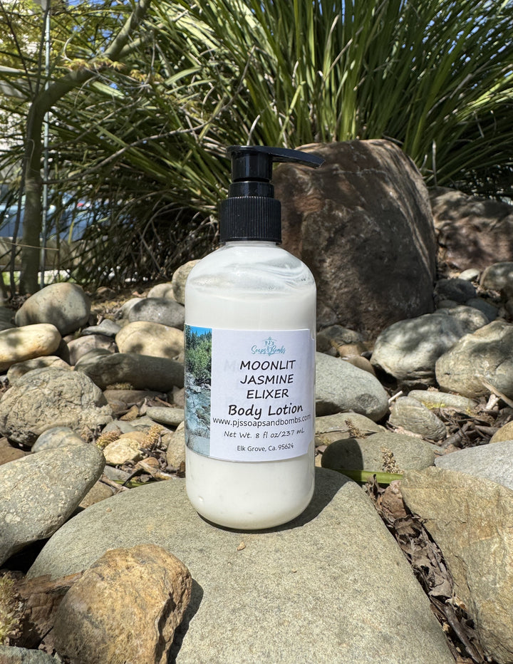 Moonlit Jasmine Elixer Body Lotion in natural setting sitting on a rock
