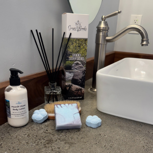 Moonlit Ocean Scent Collection displayed in a rustic bathroom setting.