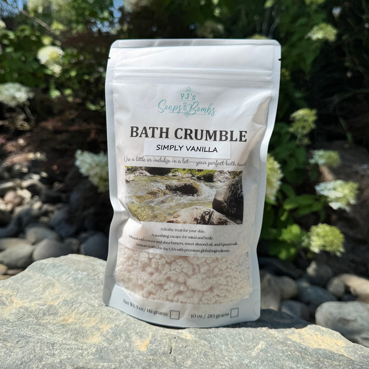 Bath crumble package labeled 'Simply Vanilla' on a rock with a natural background