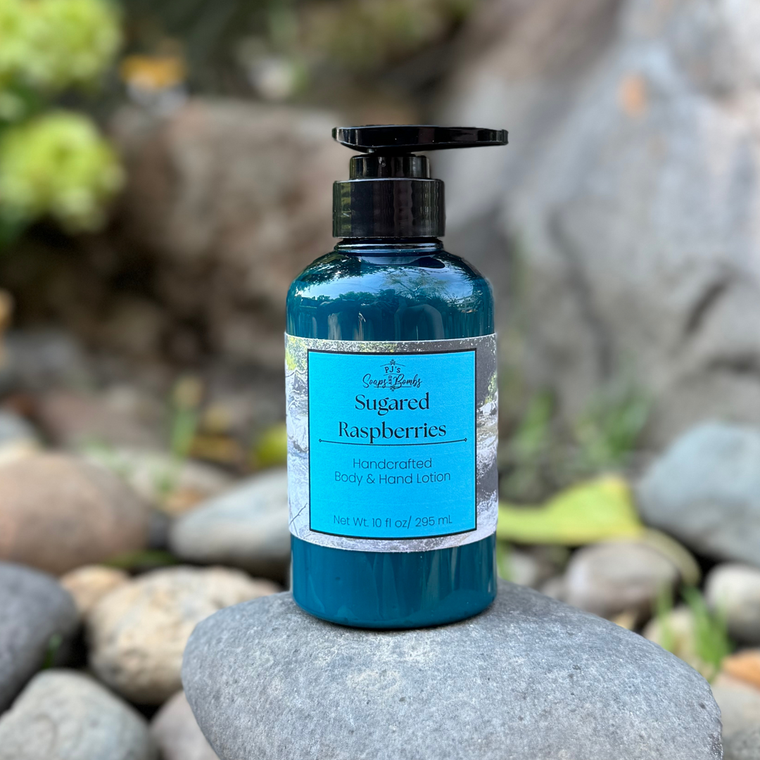 Blue bottle of 'Sugared Raspberries' lotion on a rock with a natural background
