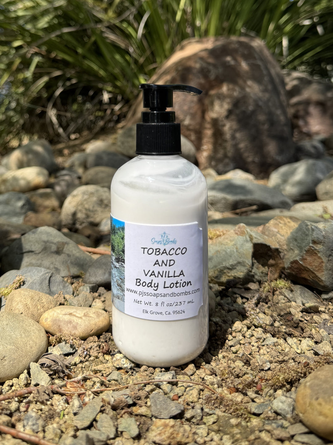 Tobacco and Vanilla Body Lotion in natural setting sitting on a rock