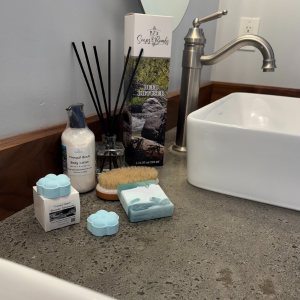 Tranquil Beach Scented Collection on a Rustic Bathroom Countertop