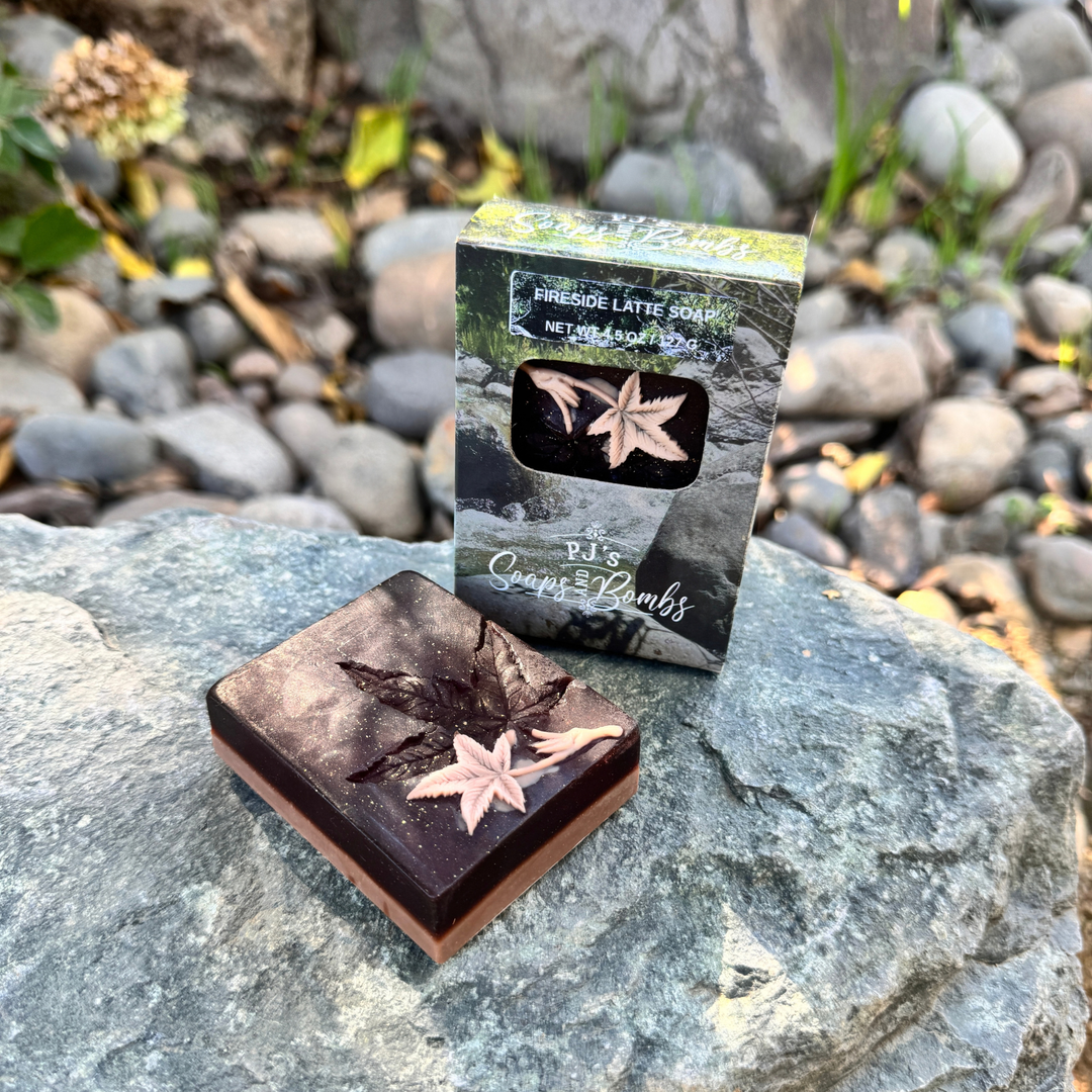 Fireside Latte Soap sitting on a rock with a boxed soap next to it.