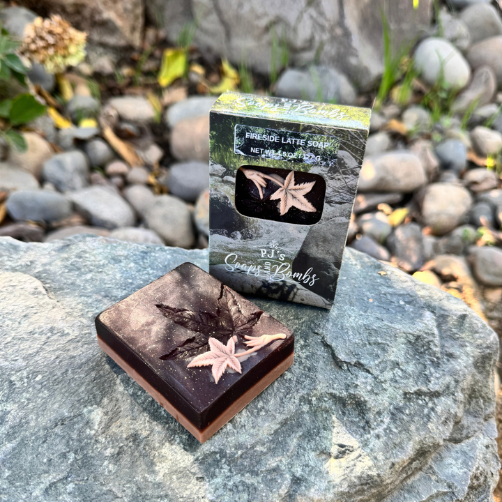 Fireside Latte Soap sitting on a rock with a boxed soap next to it.