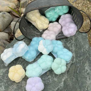 Multiple shower steamers tumbling out of bucket on a rock 
