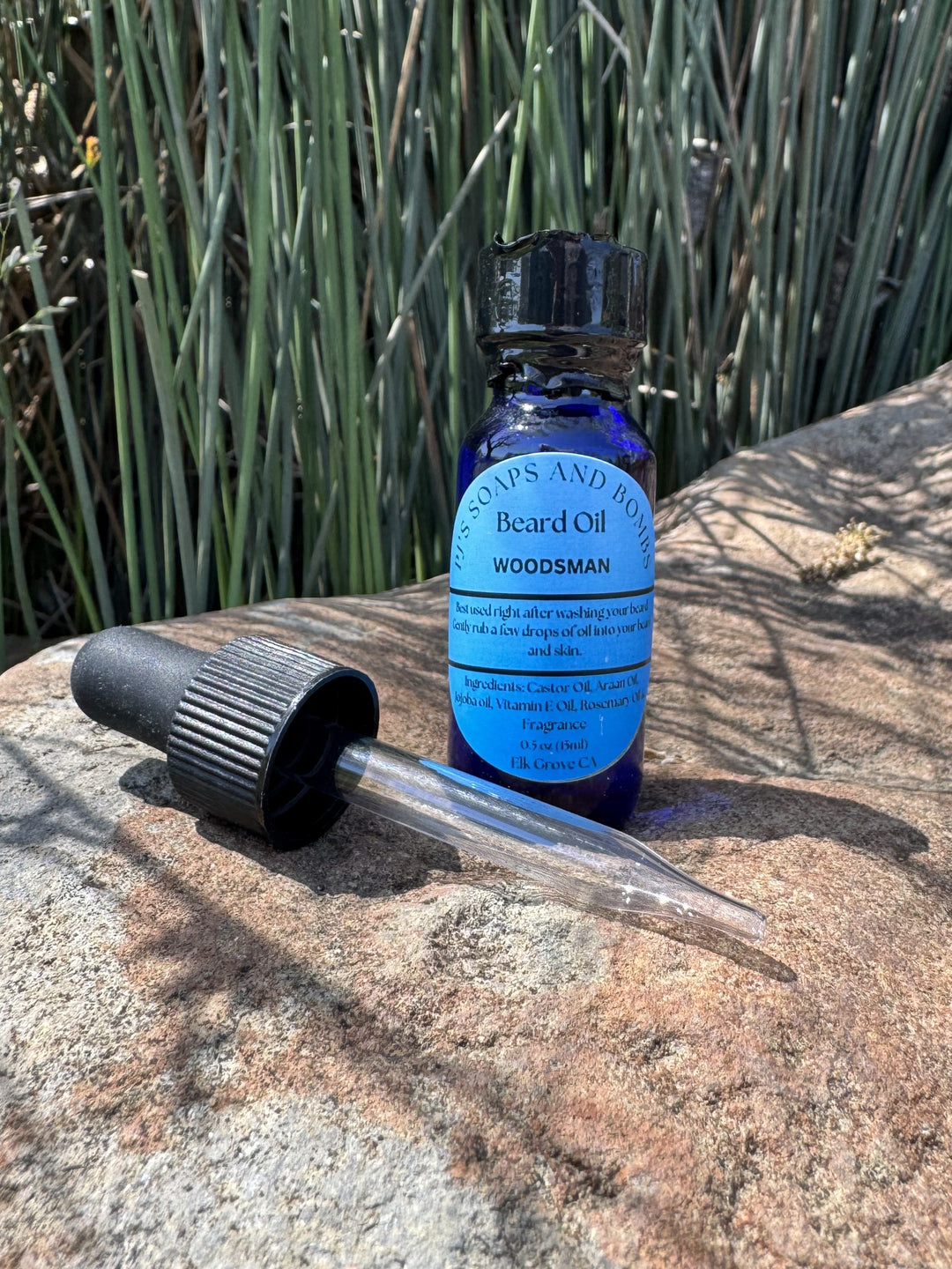 Woodsman Beard Oil and Dropper in outdoor setting